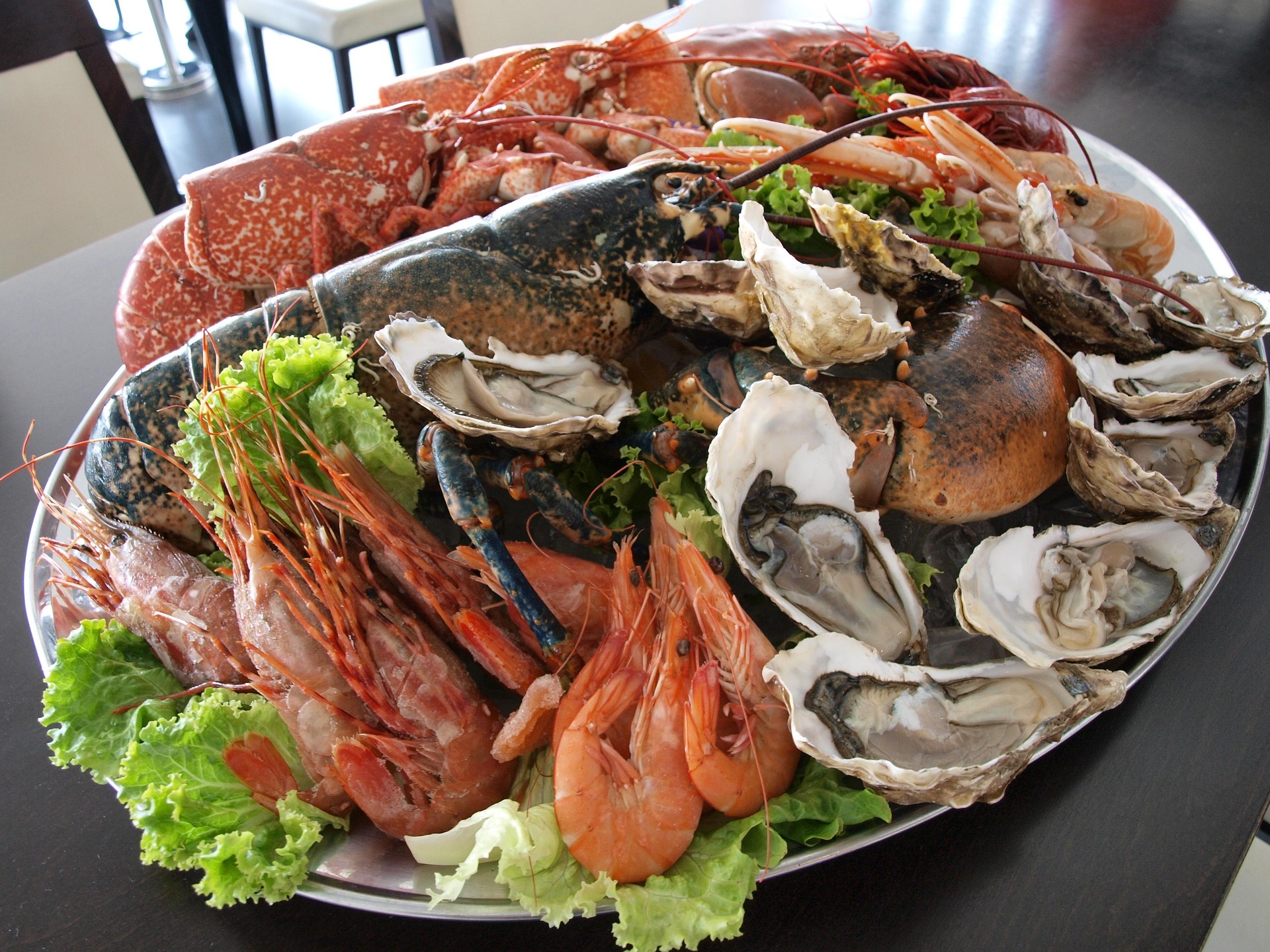 Luxury seafood platter with lobster and oysters served beside infinity pool in Tenerife